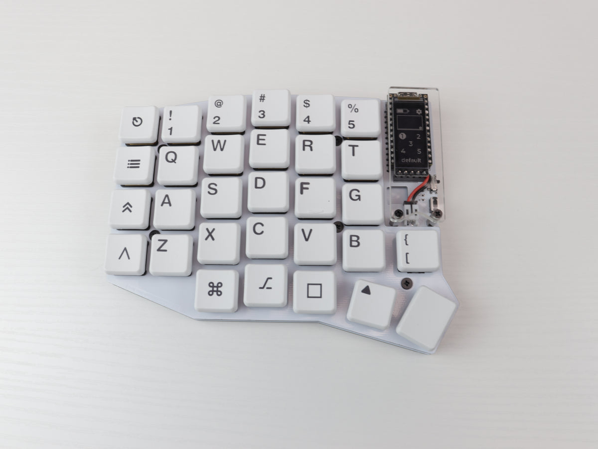 Small mechanical keyboard with white keys on a light gray background